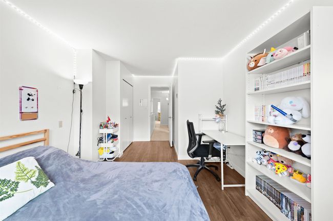 Bedroom with dark wood-type flooring | Image 26