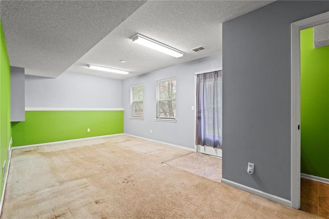 Carpeted spare room featuring a textured ceiling and baseboards | Image 33