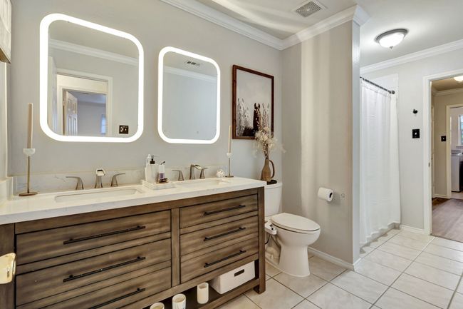 Bathroom with tile patterned flooring, ornamental molding, vanity, and toilet | Image 26