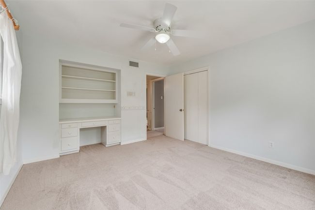 Unfurnished bedroom with light carpet, ceiling fan, and baseboards | Image 18