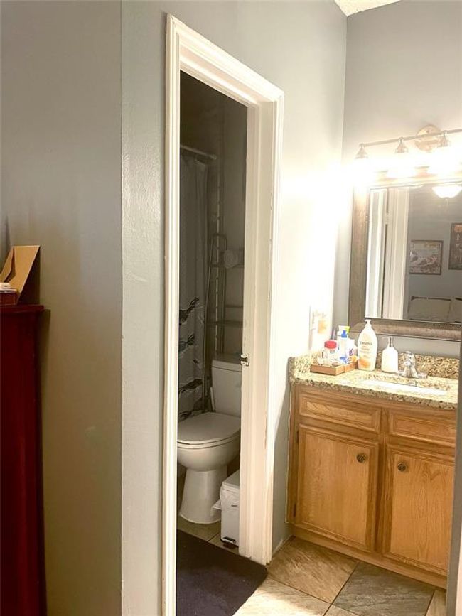 Full bath featuring toilet, vanity, and tile patterned floors | Image 5