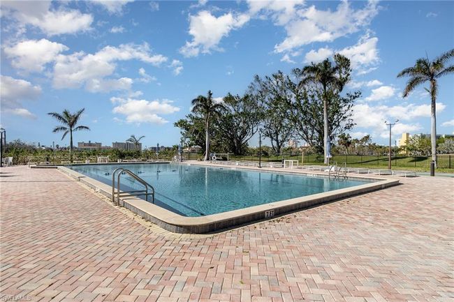 VIEW OF PAVERED COMMUNITY POOL AND SHUFFLEBOARD COURTS | Image 29