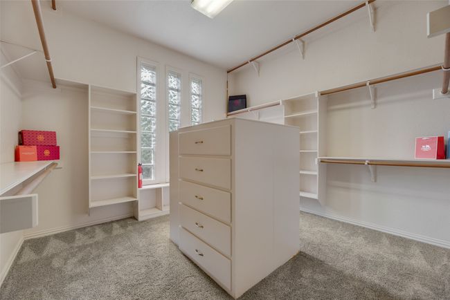 Primary closet with built in wardrobe, cedar closet attached and hidden staircase. | Image 16