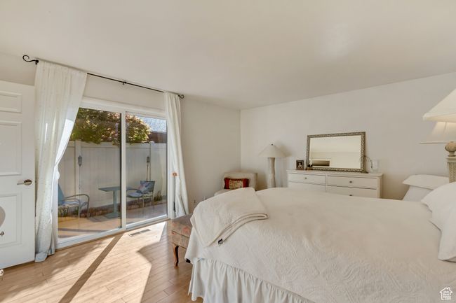 Bedroom with access to exterior, visible vents, and hardwood / wood-style floors | Image 16
