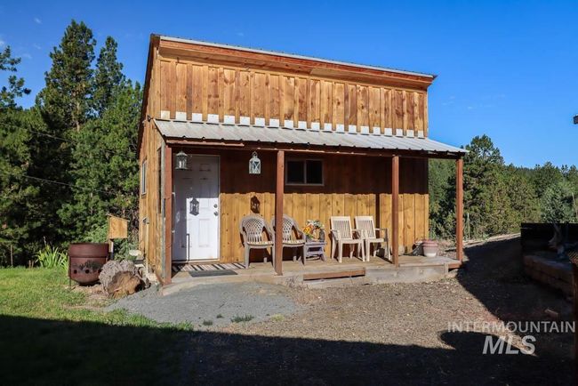 Back of property featuring board and batten siding and a metal roof | Image 42