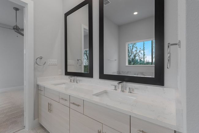 Bathroom featuring baseboards, visible vents, a sink, and double vanity | Image 26