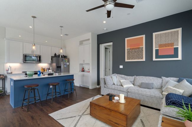 Living room with a ceiling fan, dark wood-style floors, and recessed lighting | Image 17