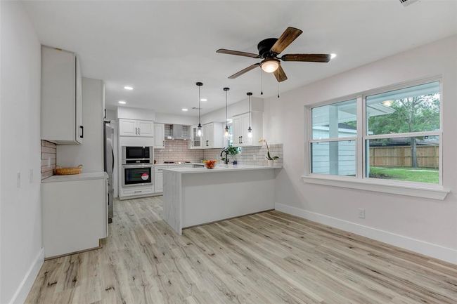 Bright and light kitchen with breakfast bar and breakfast area. New double pane windows. | Image 12