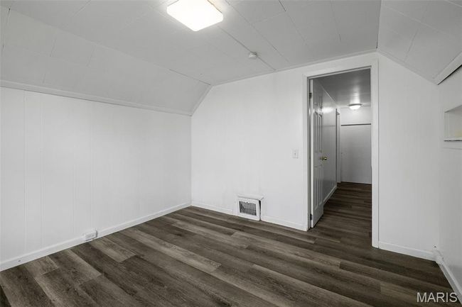 Additional living space featuring dark wood-style floors and vaulted ceiling | Image 15