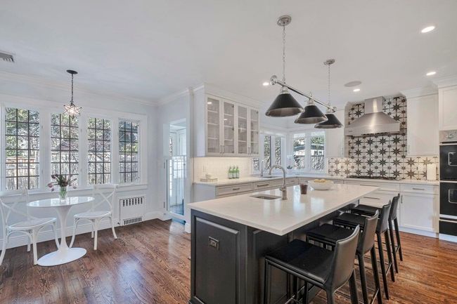 High end kitchen featuring Viking range, cooktop and two ovens, Liebherr refridgerator, Carrera marble countertops, and two sinks; entertain in style! | Image 6