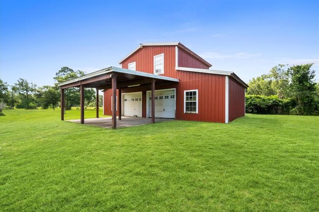 The 2 car garage offers a convenient carport in front and an efficiency apartment on the 2nd floor. | Image 20