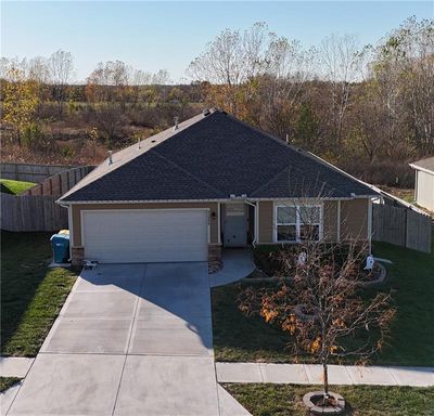 Single story home with a front yard and 2 car garage | Image 3