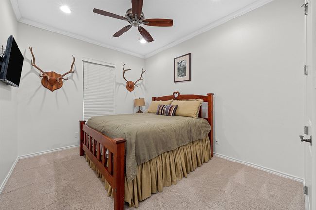 Bedroom featuring light carpet, recessed lighting, ornamental molding, and ceiling fan | Image 13