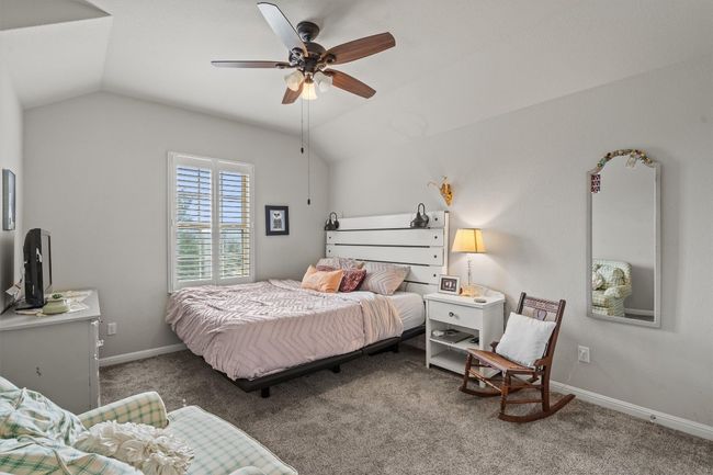 Carpeted bedroom with lofted ceiling, baseboards, and ceiling fan | Image 31