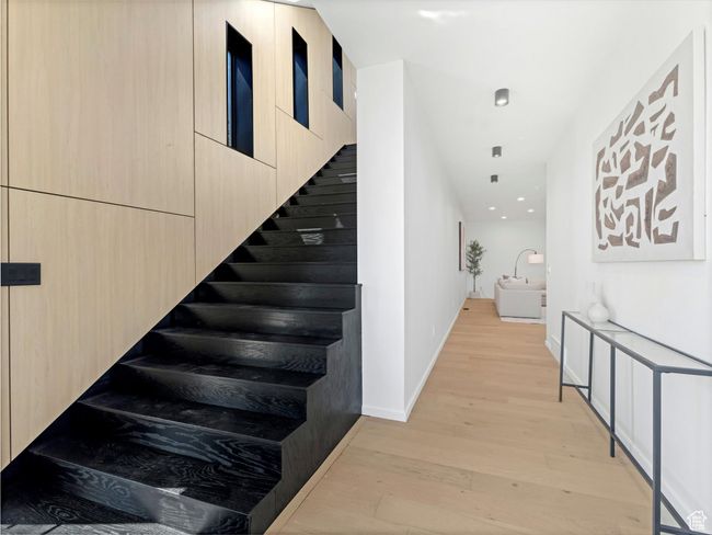 Stairway with wood finished floors and baseboards | Image 25
