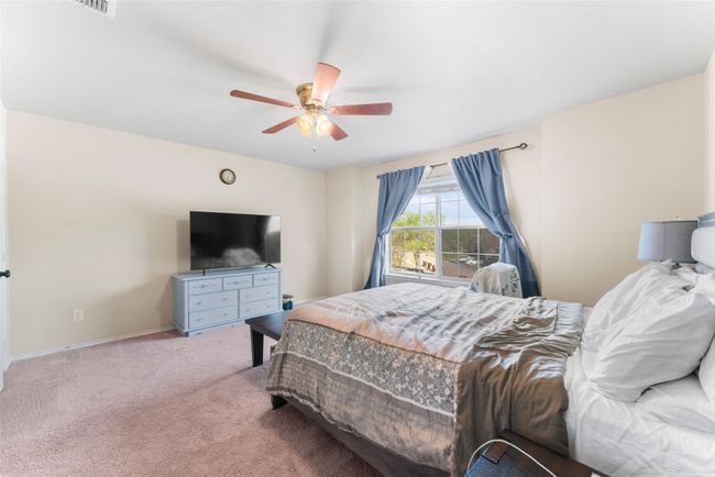 Bedroom with baseboards, carpet floors, and a ceiling fan | Image 17