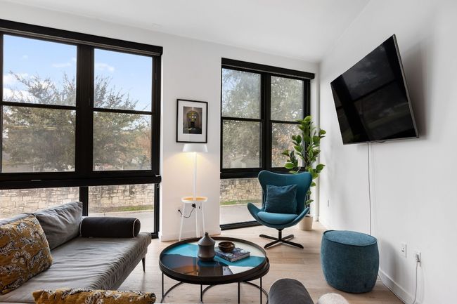 Spacious living areas that are bathed in natural light and overlook the quiet side of this building | Image 9