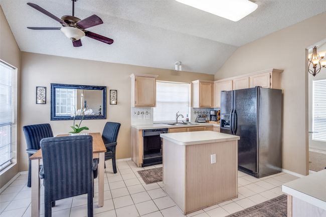 Vaulted ceilings and a neutral color scheme offer a light and bright work space for your inner chef! | Image 4