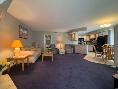 Carpeted living room featuring a textured ceiling and a chandelier | Image 3