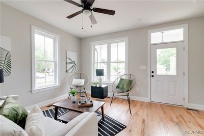 Living room featuring ceiling fan, plenty of natural light, and light wood-type flooring | Image 3