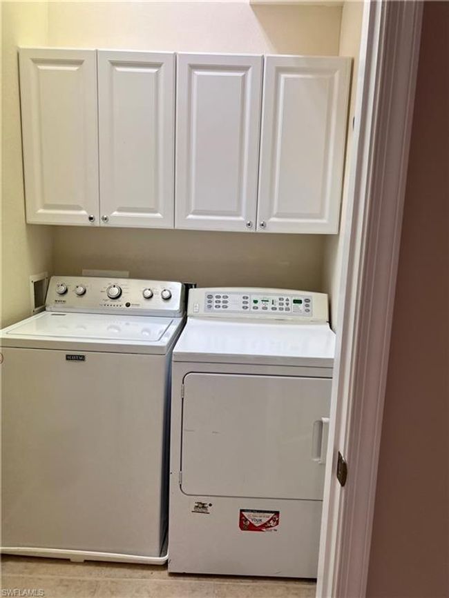 Laundry room with white cabinets | Image 26