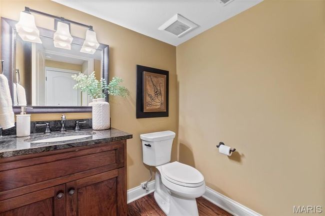 Half bathroom featuring vanity and wood finished floors | Image 46