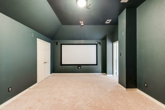 Carpeted cinema room featuring baseboards and vaulted ceiling | Image 8
