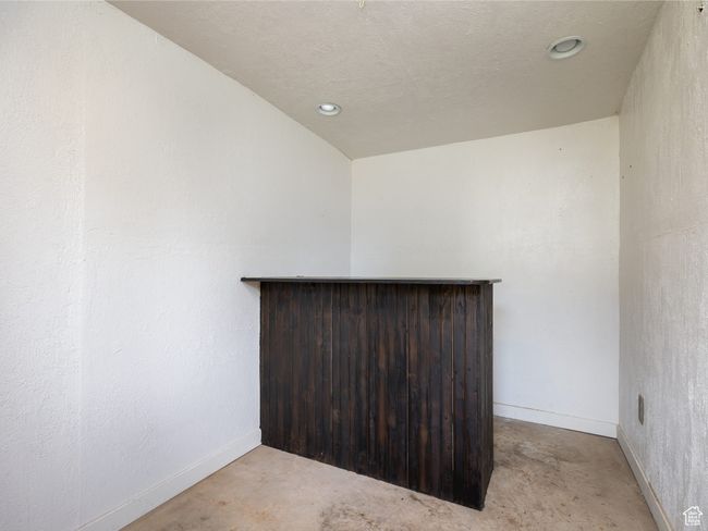 Unfurnished room featuring a dry bar, recessed lighting, and concrete flooring | Image 19