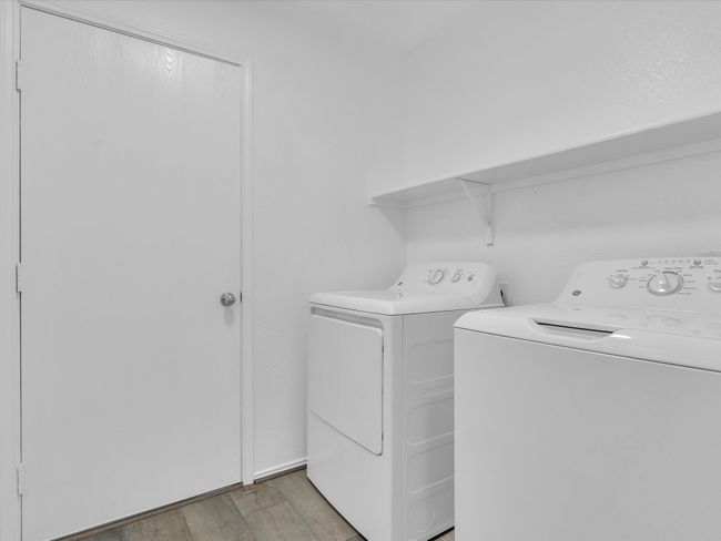 Washroom with independent washer and dryer and light wood-style floors | Image 25