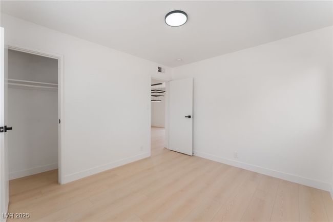 Unfurnished bedroom with light wood finished floors and a closet | Image 38