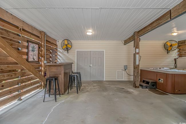 Dining area featuring unfinished concrete flooring | Image 26