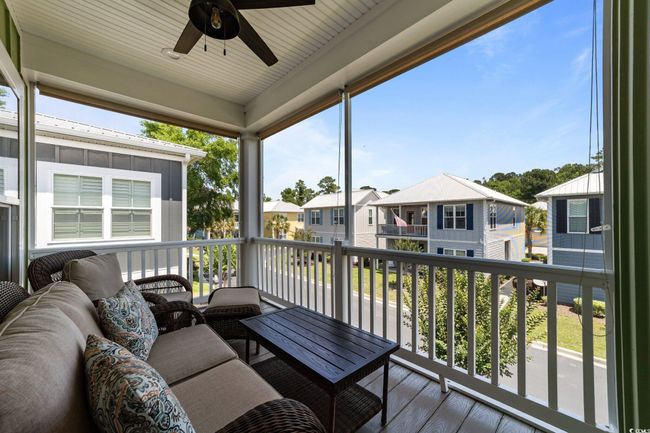 Wooden deck with a residential view, ceiling fan, and an outdoor hangout area | Image 29