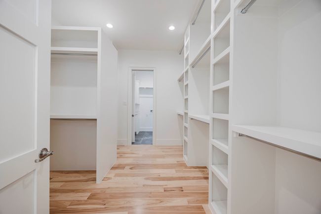 Walk in closet featuring light wood finished floors | Image 21