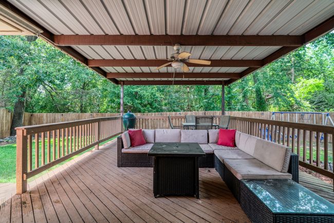 Wooden terrace featuring an outdoor living space, a ceiling fan, and a fenced backyard | Image 16