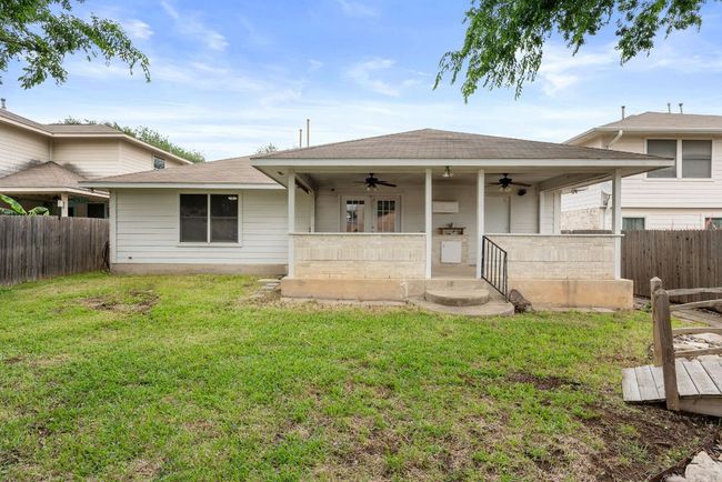 View of front facade featuring fence private yard, a ceiling fan, a front lawn, and roof with shingles | Image 30
