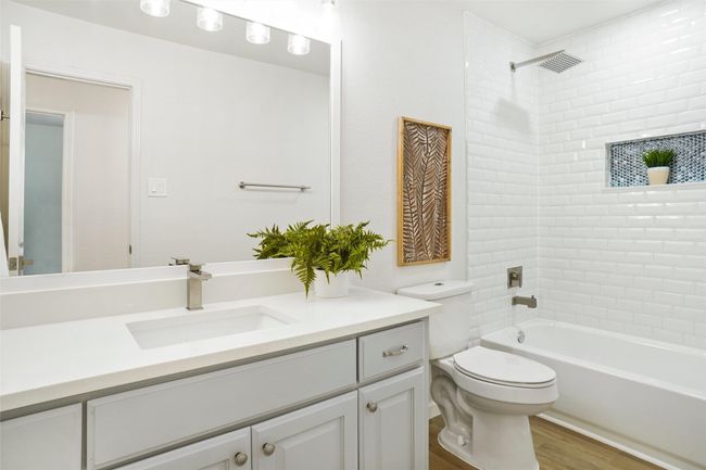 Bathroom with vanity, toilet, tub / shower combination, and wood finished floors | Image 21