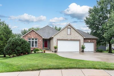 View of front of home featuring a front lawn and a garage | Image 1