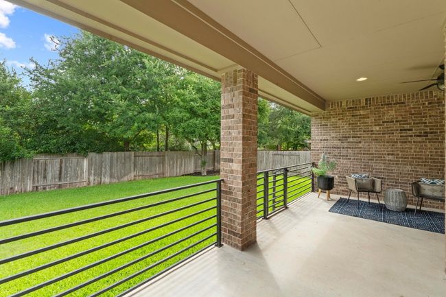 Fenced backyard with a patio area | Image 37