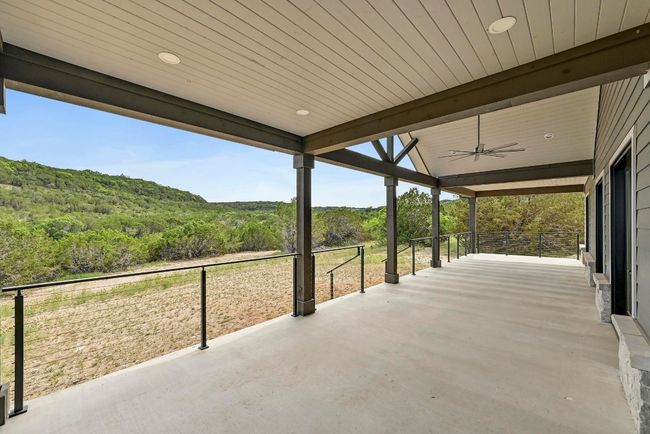 This incredible oversized back porch provides you with ample space for living, dining, entertaining, a grill station, and more. | Image 37
