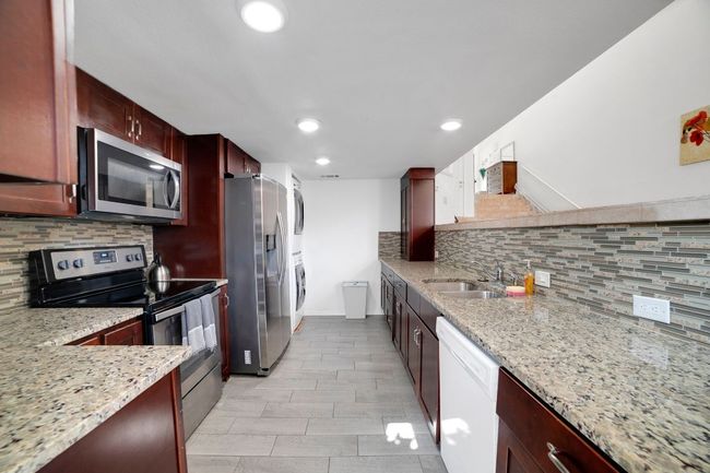 Kitchen with stainless steel appliances, granite countertops, laundry room and recessed lighting | Image 8