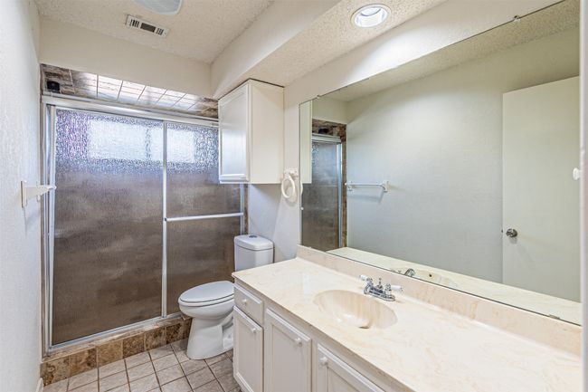 Bathroom with vanity, a stall shower, and tile patterned floors | Image 24