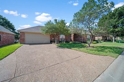 Single story home with a front yard and a garage | Image 1