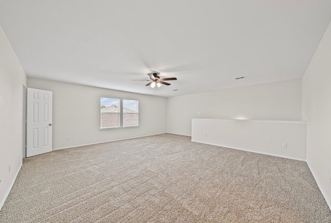 Carpeted spare room featuring a ceiling fan and baseboards | Image 26