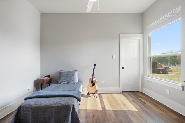 Sitting room featuring wood finished floors, baseboards, and a ceiling fan | Image 16