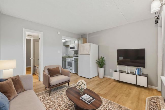 Living room with light wood finished floors and baseboards | Image 4