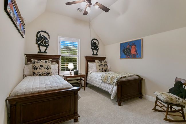 UPSTAIRS Bedroom featuring lofted ceiling, light carpet, and a ceiling fan. Behind each side of the room there are closets, the full length of the walls! AMAZING STORAGE! | Image 26