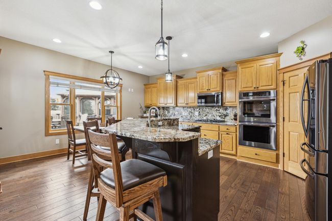 Granite countertops, stainless appliances, eat in kitchen | Image 11