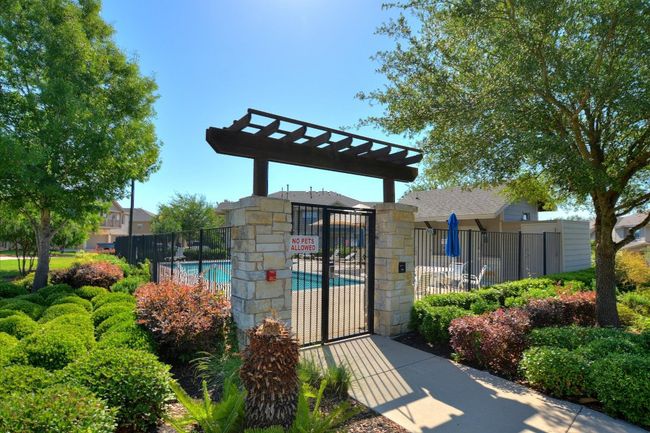 View of property's community featuring a pool and a gate | Image 23