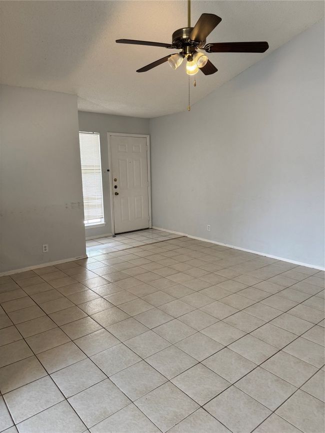 Spare room featuring a textured ceiling, light tile patterned floors, and ceiling fan | Image 11