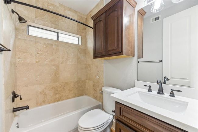 Guest bathroom for the two secondary bedrooms on the first floor. New vanity and lights added in 2025. Shower/tub combo for convenience. | Image 24